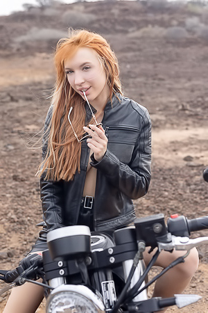 Lilly Mays Rides A Motorcycle In The Desert Wearing A Leather Jacket And Miniskirt